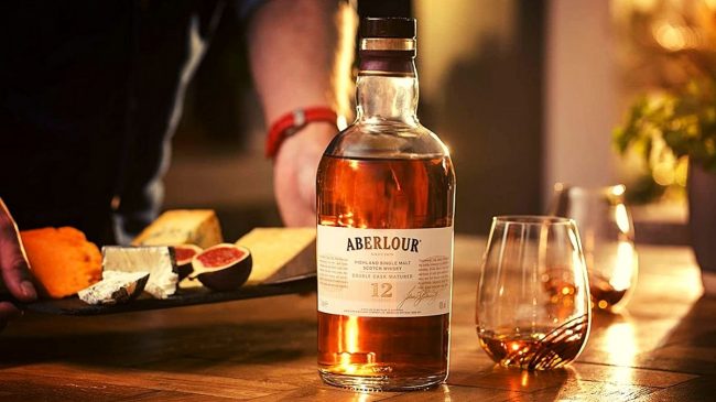 aberlour 12 year old whisky bottle and glass on table