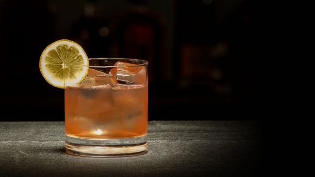 larceny 92 proof bourbon on glass with lemon and ice