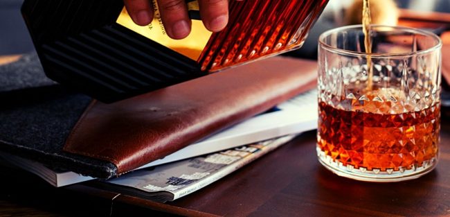 man pouring old crow bourbon