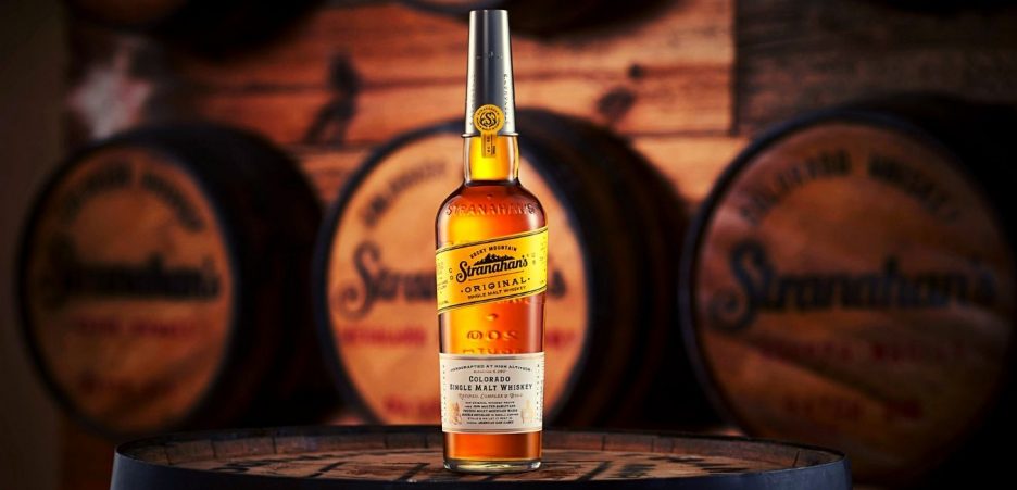 stranahans whiskey bottle and barrels